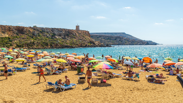 Sunbathers on the beach at Golden Bay in Malta