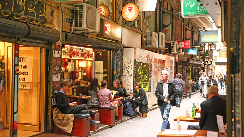 People sitting outside of cafes on Degraves Street, one of Melbourne's iconic laneways