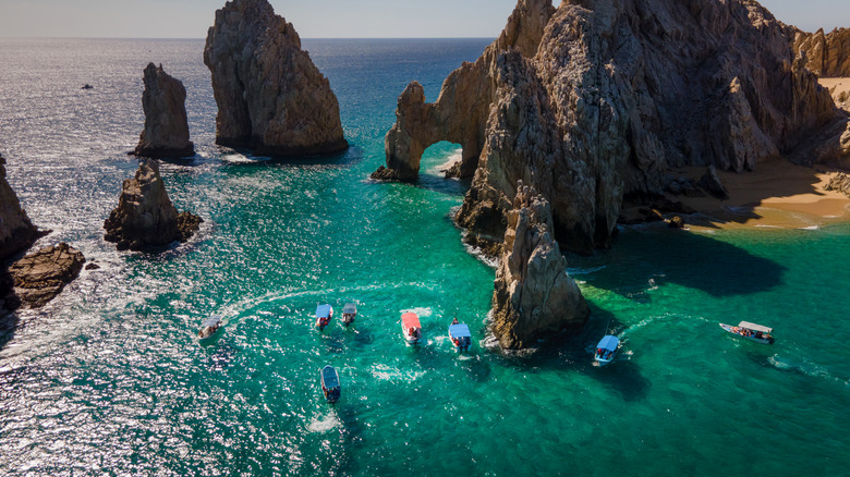 Rock formations at Cabo San Lucas, surrounded by boats