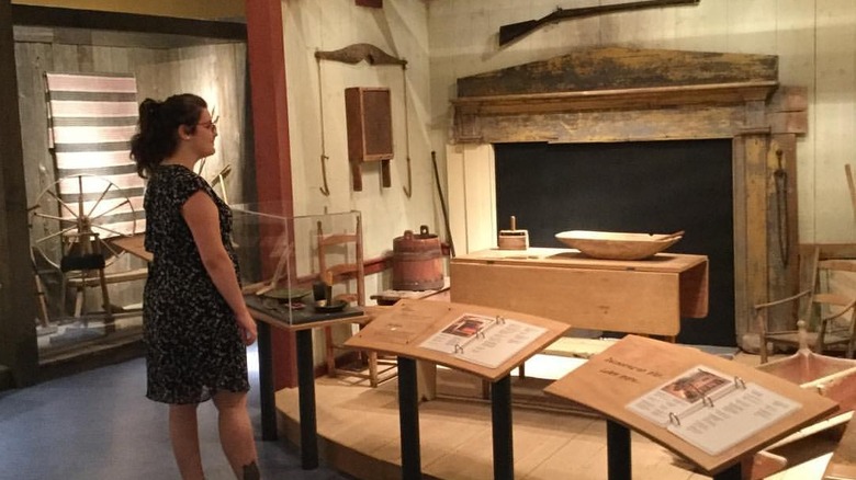 A museum visitor looks at an exhibit at the Musée Acadien