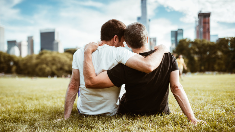 Gay couple from behind overlooking New York's skyline from Central Park