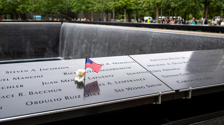 A flower and a small U.S. flag at the 9/11 Memorial in New York City