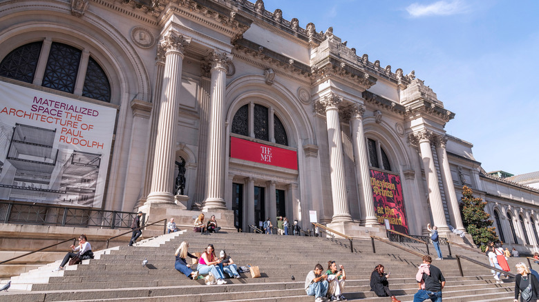 People sit on the steps outside the Metropolitan Museum of Art