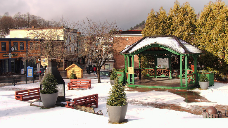 The village of Saranac Lake with benches and a gazebo surrounded by snow