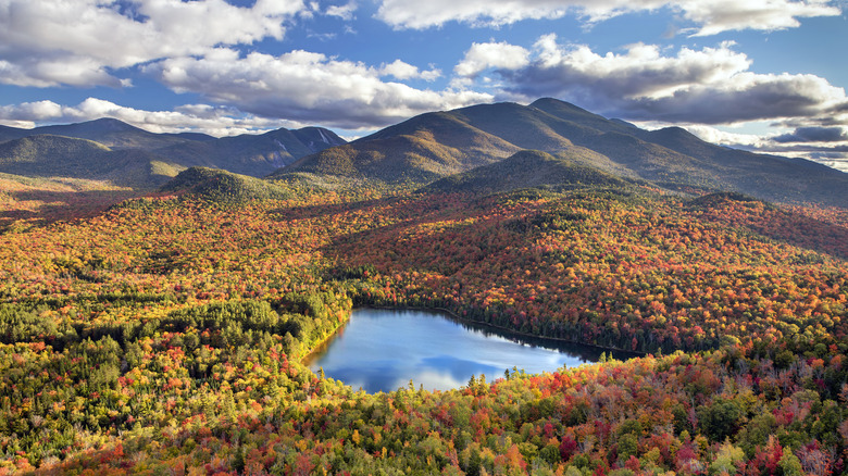 A view of the Adirondack Mountains, a lake, and the changing fall leaves from Mount Jo, New York