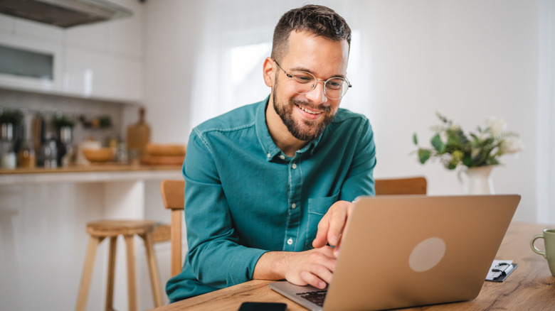A man using his laptop at home