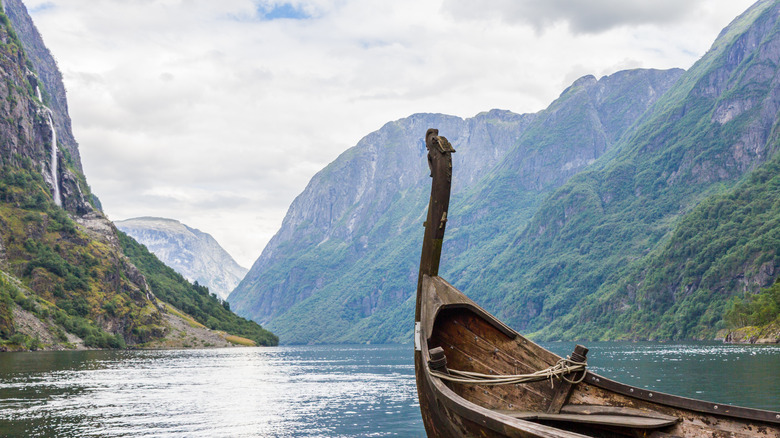 Traditional Viking boat overlooking a Norwegian fjord and a waterfall