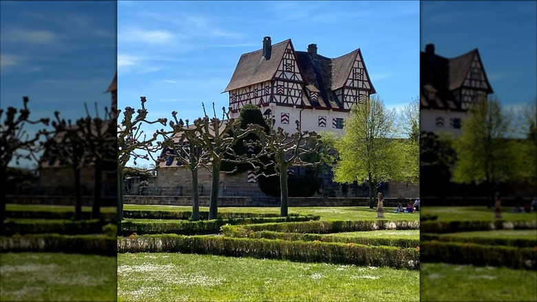 The fortified manor house of Schloss Neunhof rises out of a garden