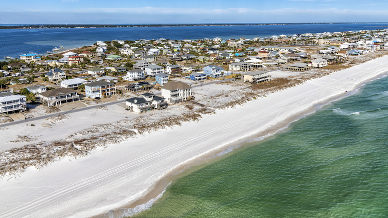 aerial view of Pensacola Beach with buildings, white sand beach, and the ocean on each side