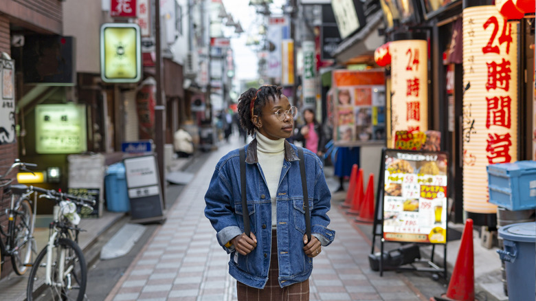 A young tourists wanders the the streets of Tokyo.