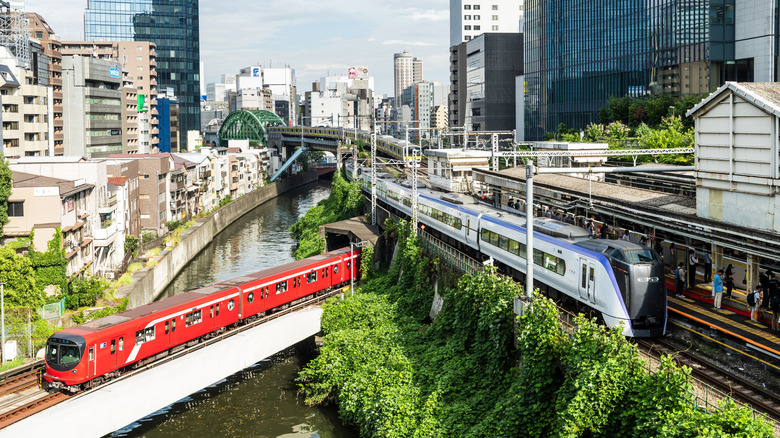 Aerial view of Japan's trains exiting a platform in the heart of the city.