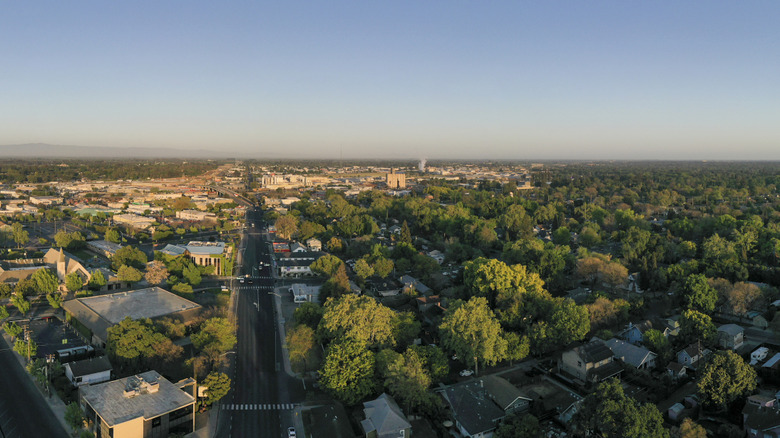 Aerial view of Modesto, featuring historic buildings, lush green trees, and wide roads.