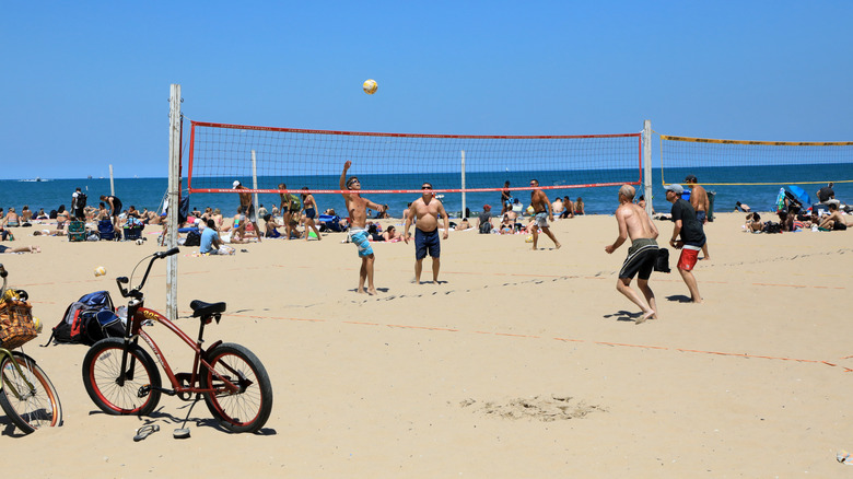 A summer beach volleyball match in progress at Oak Street Beach in Chicago