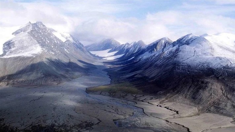 An ariel view of the Arctic landscape with jagged, snow-capped mountains in Quttinirpaaq National Park, Nunavut, Canada