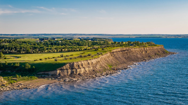 A breathtaking aerial view captures the expansive shoreline of North Dakota's Lake Sakakawea at sunset