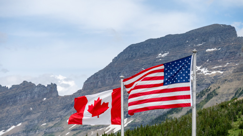The Canadian and American flags wave side by side in Waterton-Glacier International Peace Park