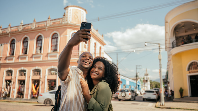 African American couple smiling taking a selfie