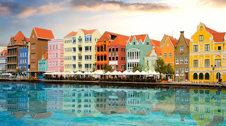Colorful buildings of Curaçao's capital Willemstad reflecting in the Caribbean blue harbor at sunset