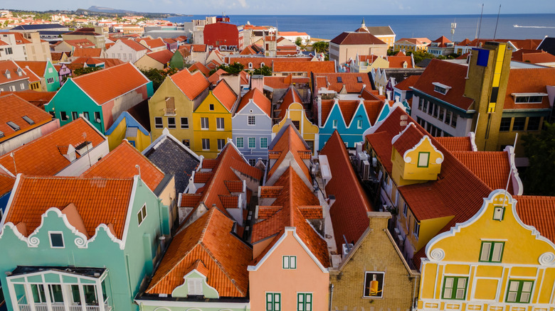 Aerial view of colorful buildings and red roof near the ocean in Willemstad, Curaçao