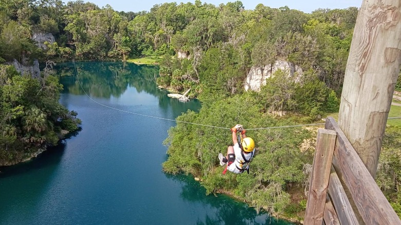 Someone zip-lining at Canyons Zip Line and Adventure Park in Ocala