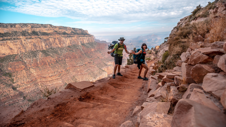 A couple walking through the Grand Canyon.