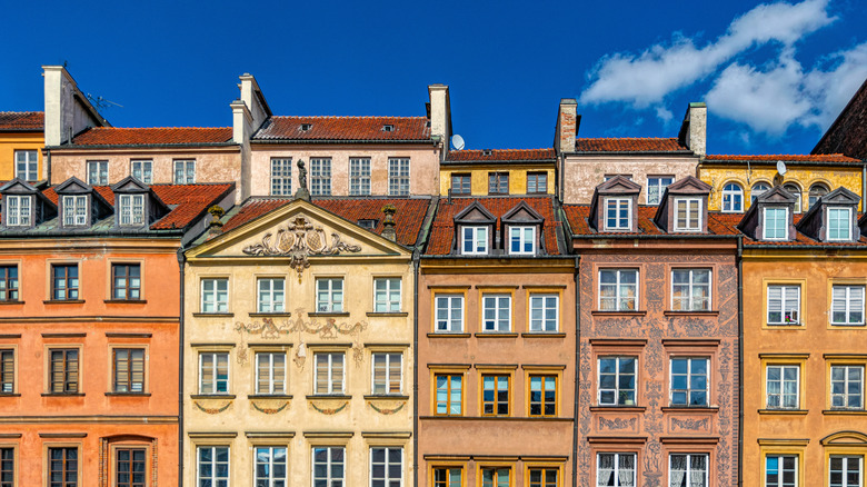 Colorful facades in Warsaw's Old Town, Poland, under a blue sky