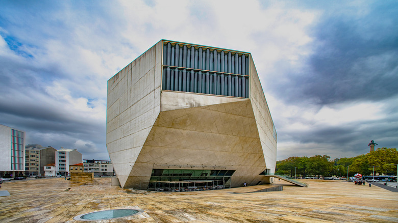 White polyhedron building exterior on dark cloudy day