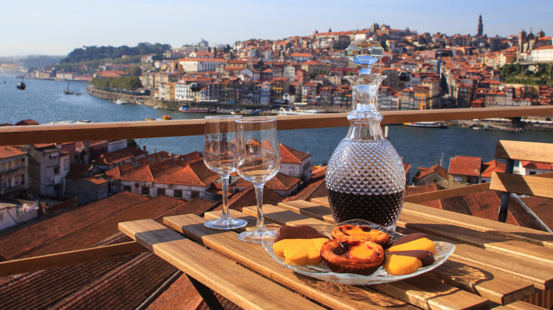Table with wine and a view of Porto in background