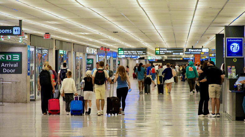 Passengers walking through the baggage claim area at Washington Dulles International Airport