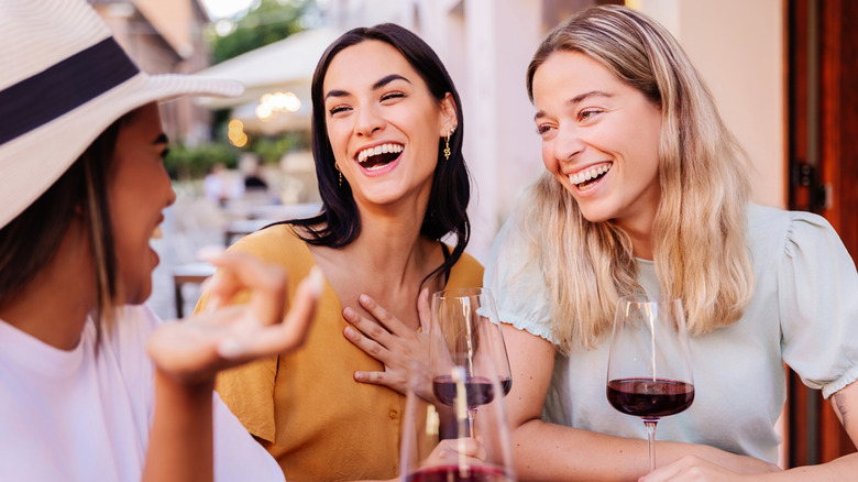 People drinking wine at a cafe in Rome