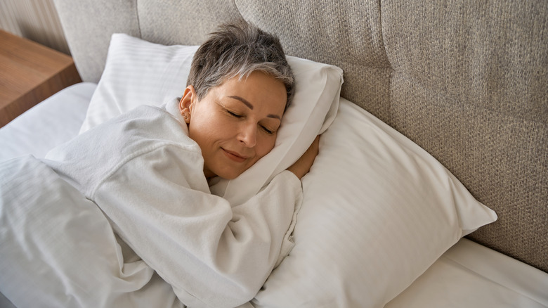 Someone sleeping in a hotel bed
