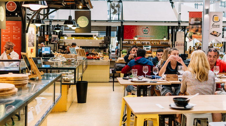 Diners having lunch at Mercado de Campo de Ourique in Lisbon