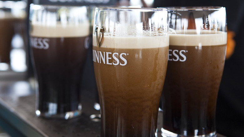 A round of Guinness settles on a bar in Ireland