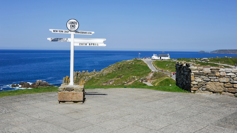 Lands End sign on the southern coast of England in Cornwall on a sunny day overlooking the blue ocean