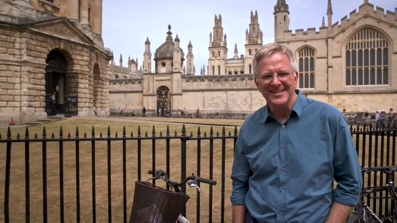 Rick Steves standing near a fence outside of Oxford University