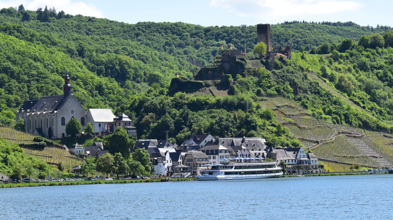 Passenger ship docked at Beilstein with tree-covered hills in the background