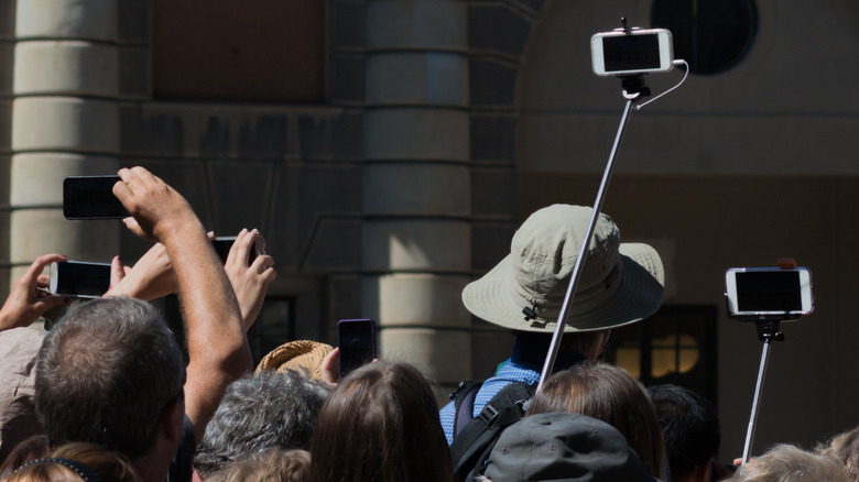 A sea of cameras and selfie sticks