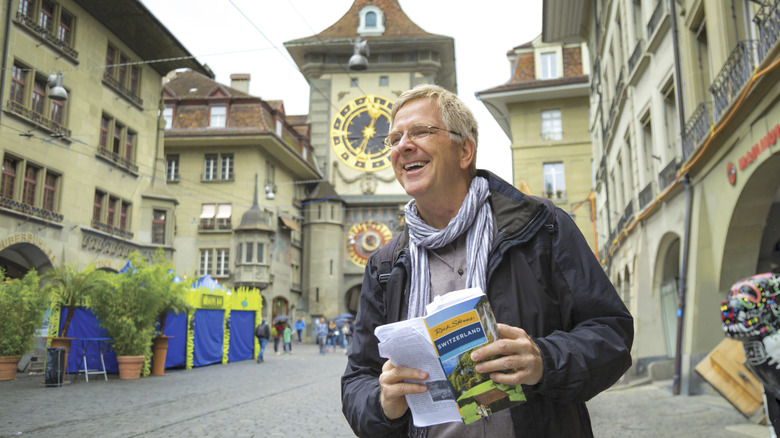 Travel writer Rick Steves holds one of his guidebooks while exploring Bern, Switzerland.