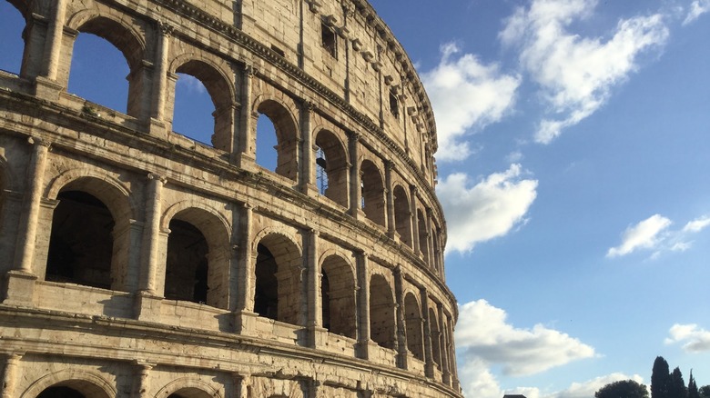 Side of the Colosseum against a blue sky