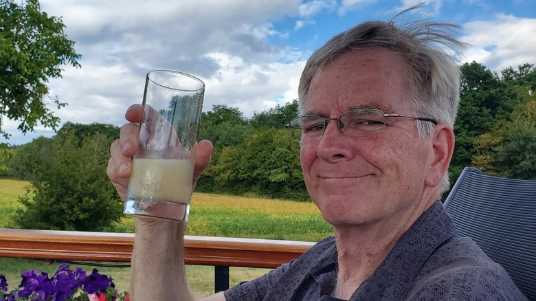 Rick Steves holding up a glass