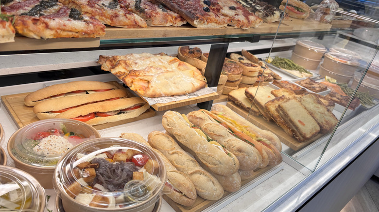 Sandwiches, pizza, and dessert in a Paris bakery