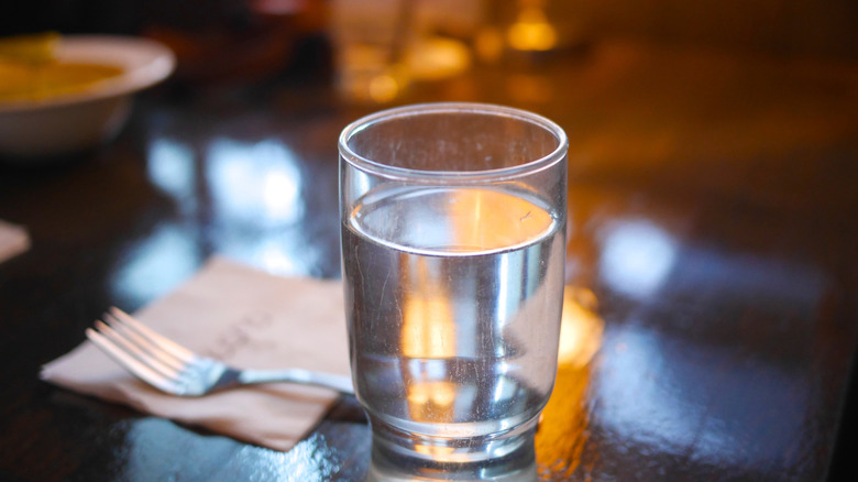 A glass of tap water on a restaurant table
