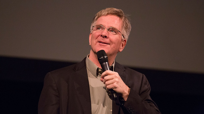 Rick Steves on stage with microphone