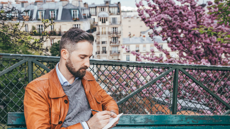 Someone journaling in a park in Paris