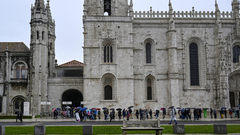 Tourists lining up outside a building