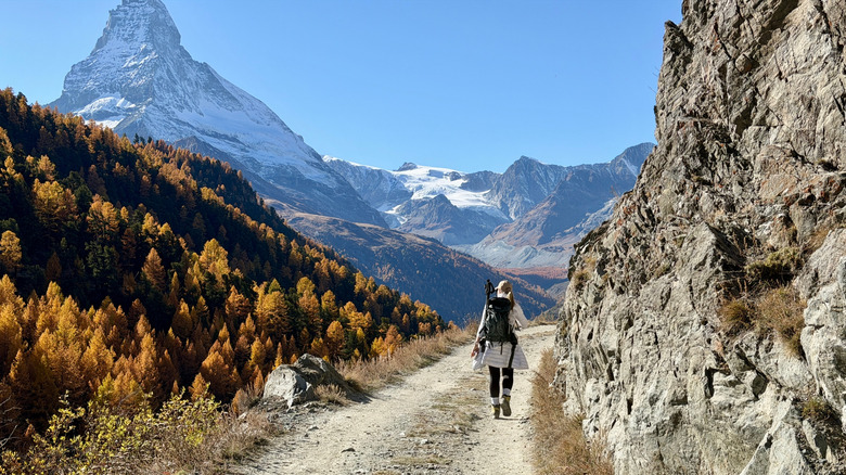 Hiker in the mountains above Zermatt, with the Matterhorn in view