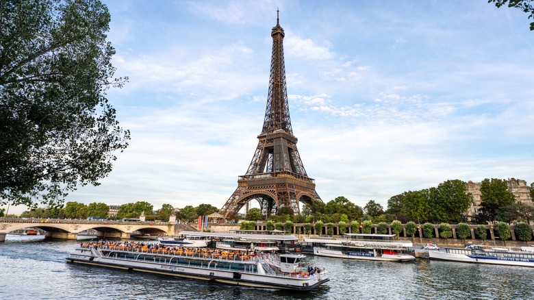 The Eiffel Tower in Paris, France, with boats on the river in the foreground