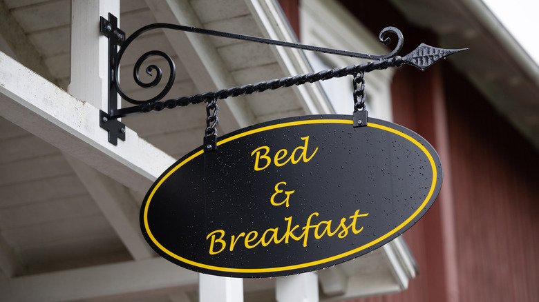 A sign for a bed and breakfast hangs over an entrance