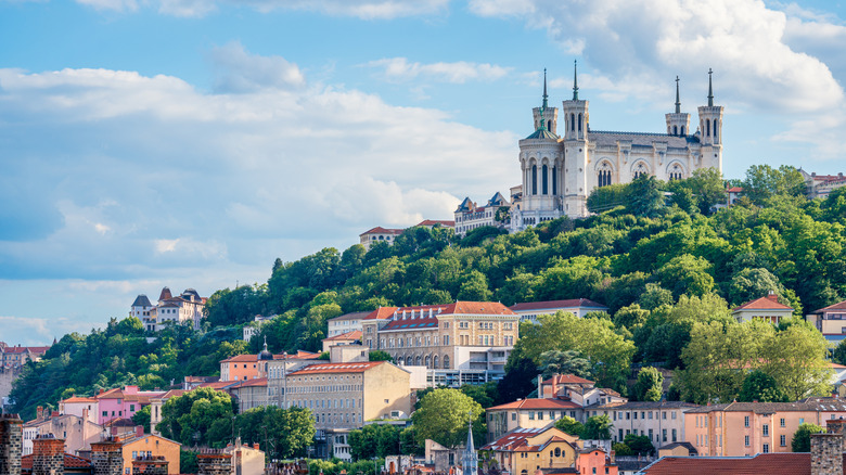 The Basilica of Notre Dame in Lyon, France, atop a lush hill