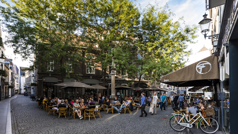 People sitting at an outdoor cafe in the town of Maastricht in the Netherlands